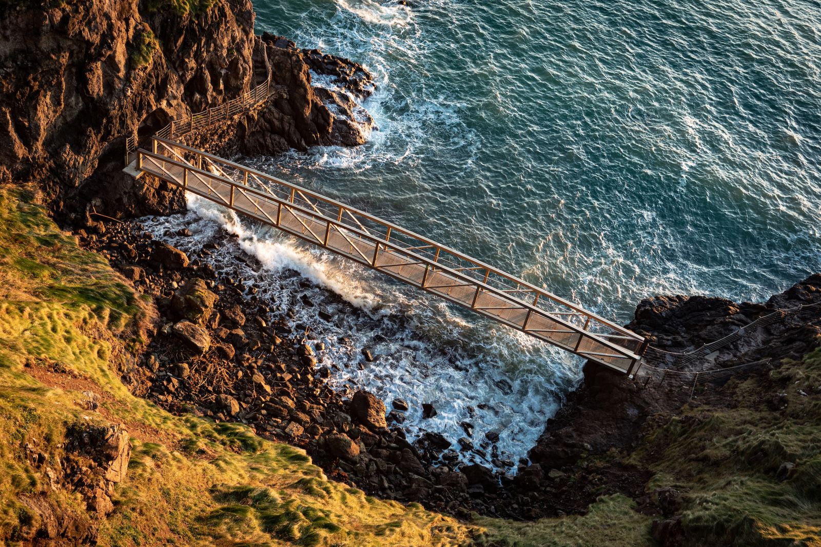 Ariel view of one of the bridges at The Gobbins, stretching over a cove